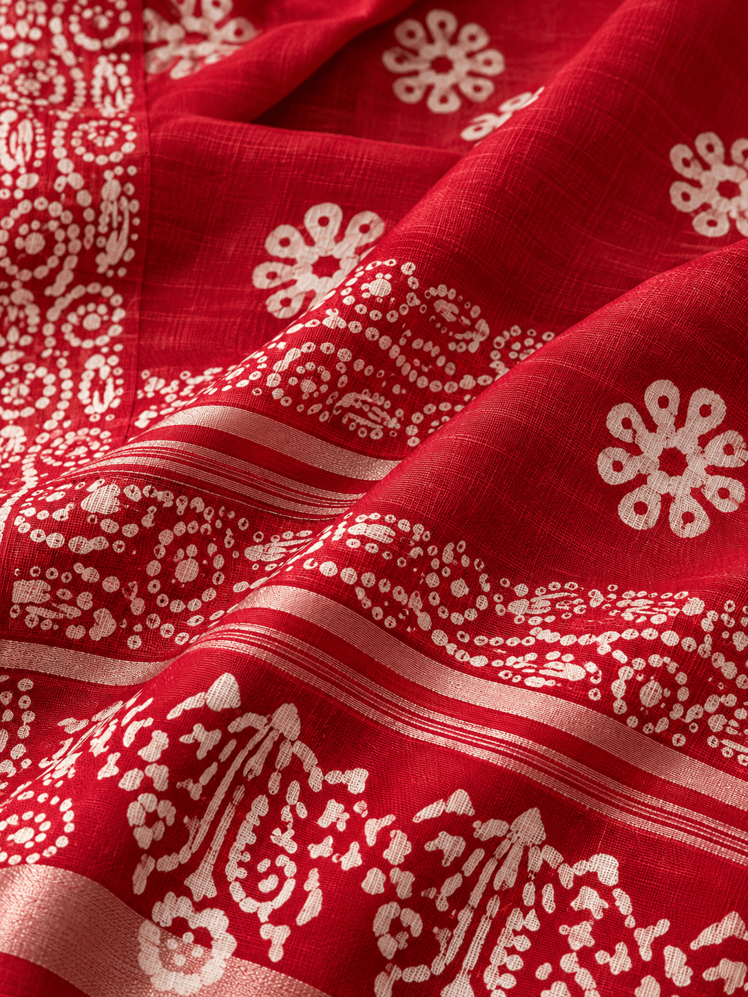 red batik textile in soft folds red batik textile in soft folds